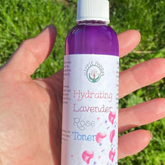 Facial toner bottle with purple liquid, white cap, and Hippie Pharm label held in hand