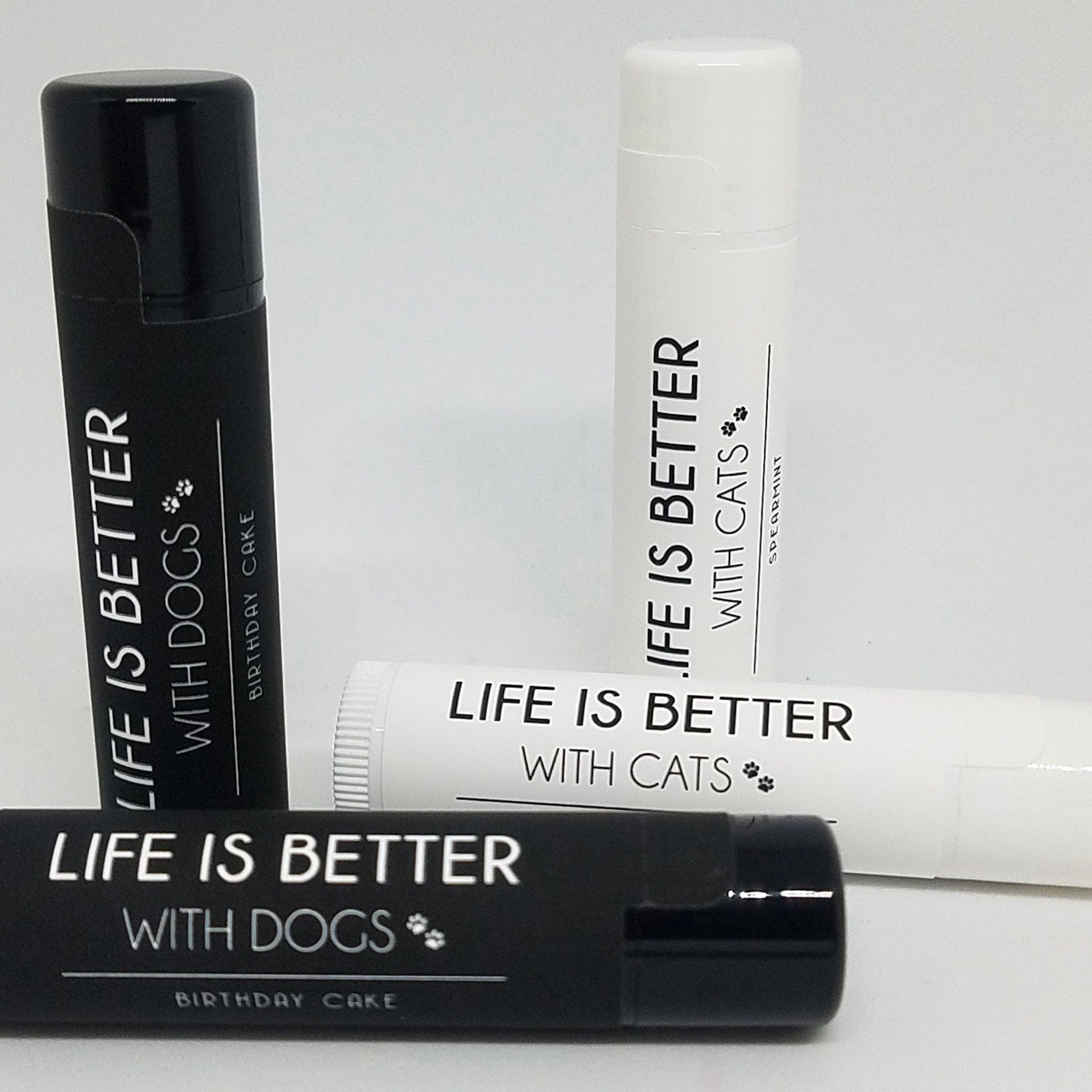 Lip balm tubes in black and white with "Life is Better" text and pet themes