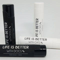 Lip balm tubes in black and white with "Life is Better" text and pet themes
