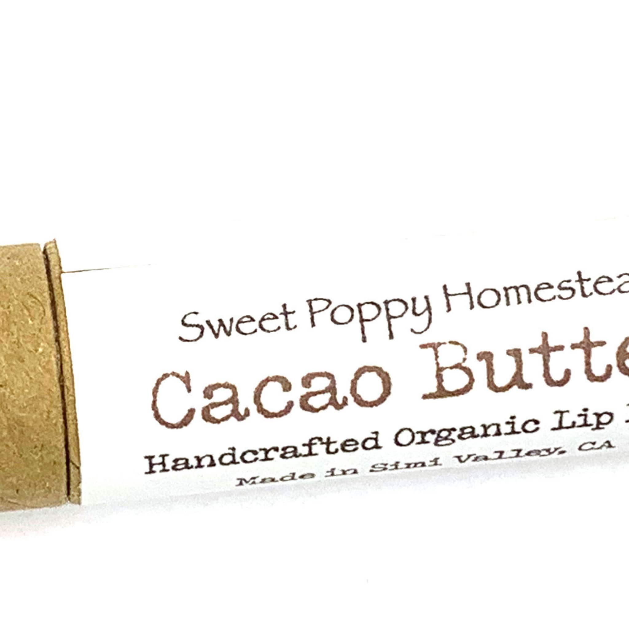 Cacao Butter lip balm tube with brown text on white paper and tan cardboard end