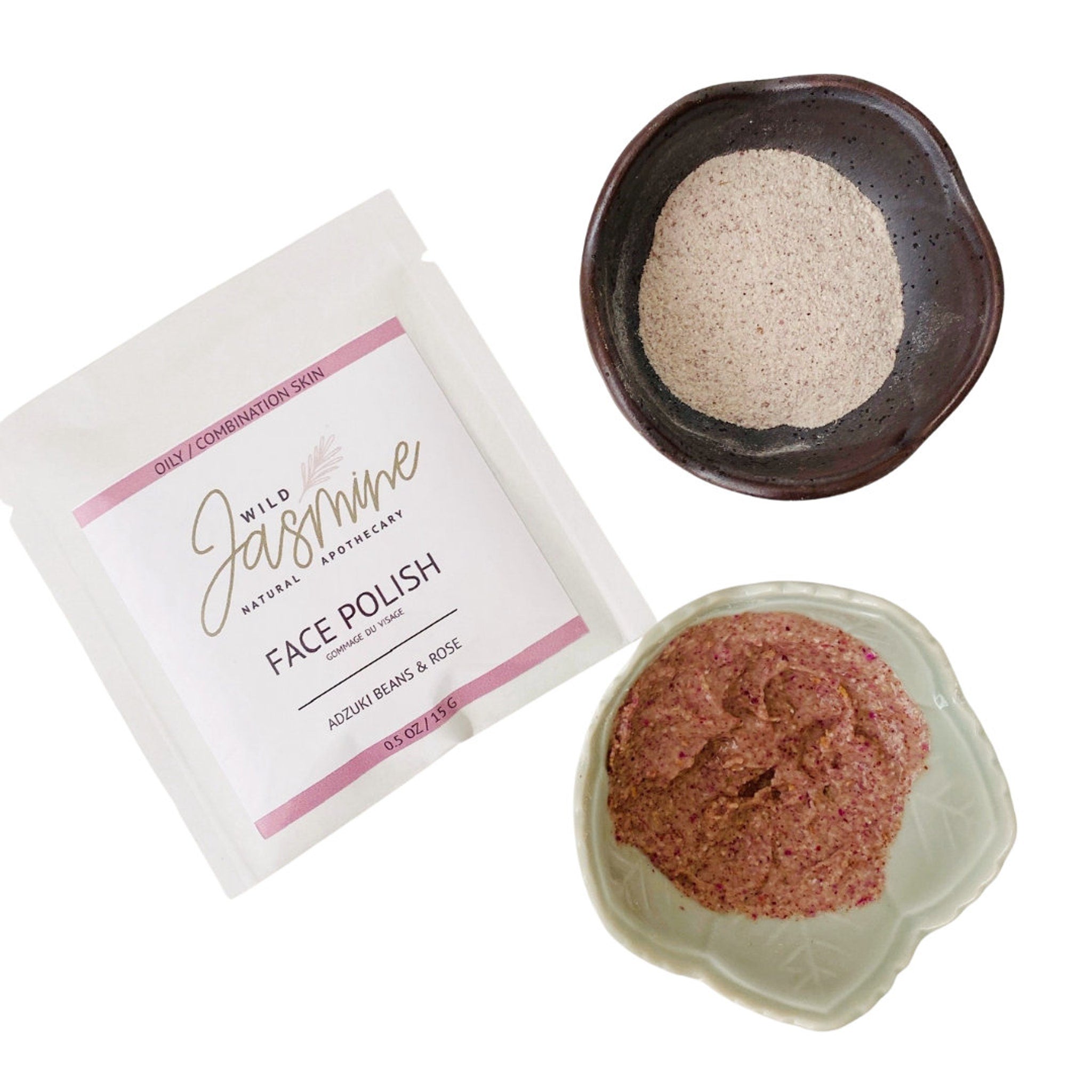 Face polish with white packet, pink accents, and Wild Jasmine branding, plus brown and pink product in bowls