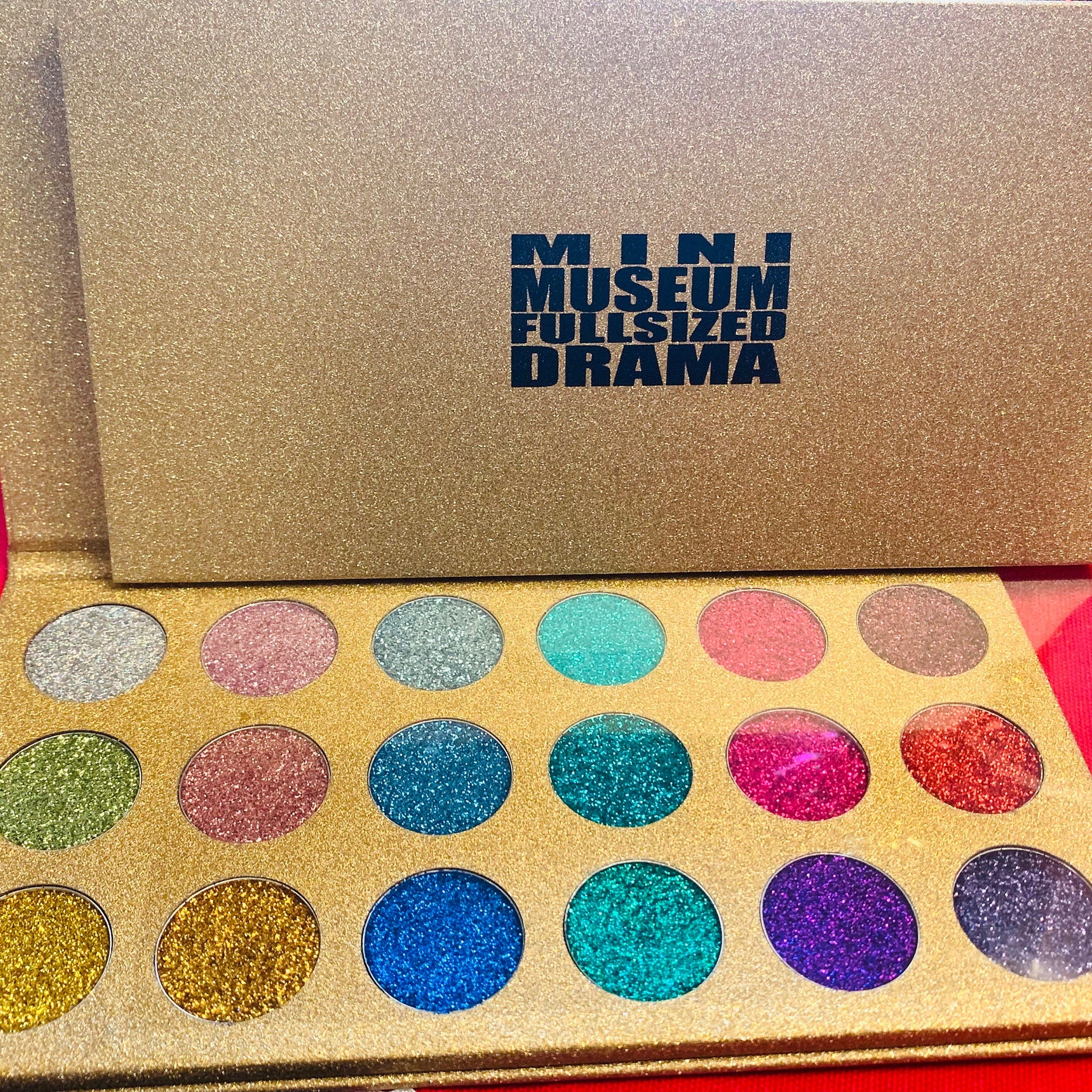 Glitter eyeshadow palette with gold and multi-color glitter shades, SMCA brand name visible