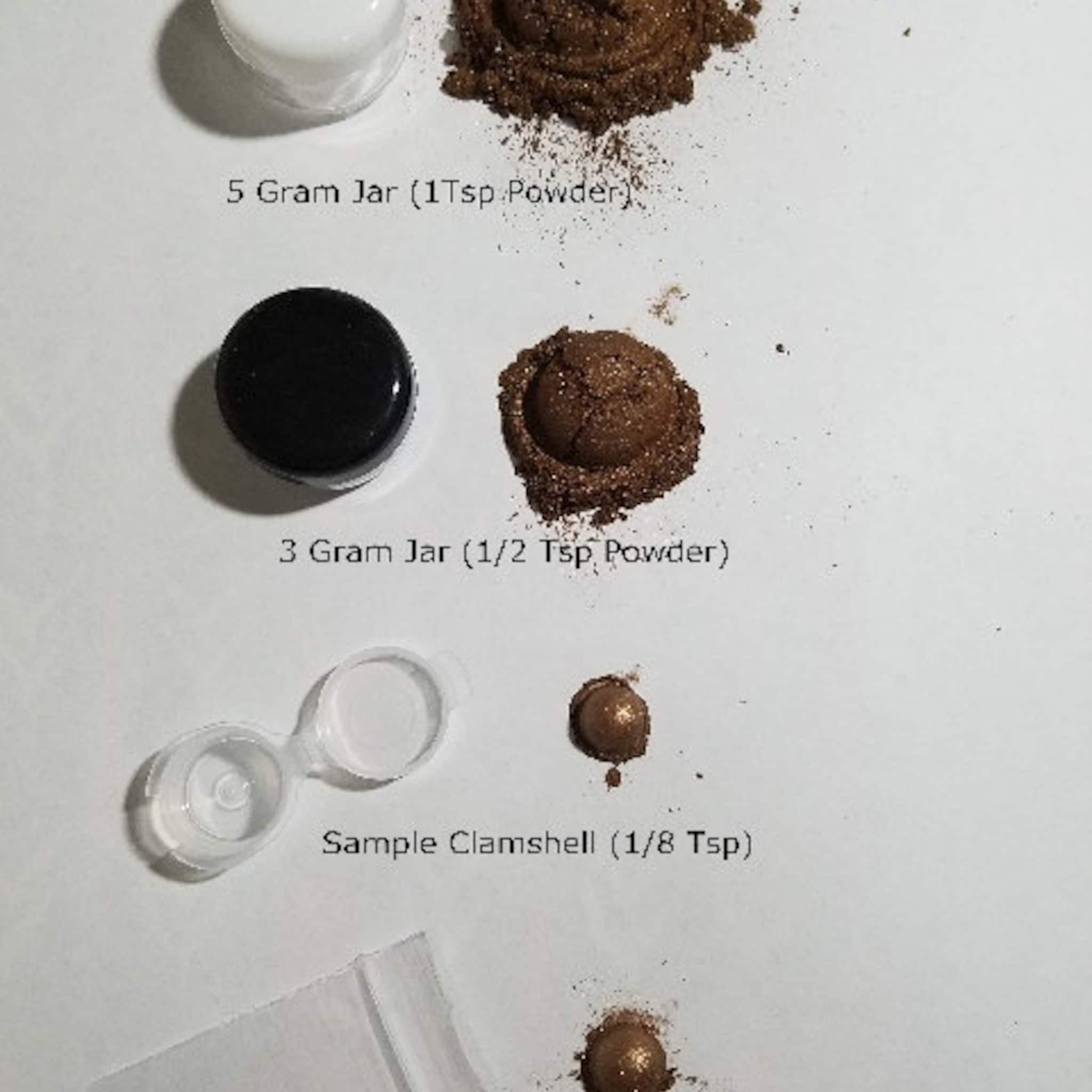 Side view of NYX Professional Makeup Eye Shadow compact showcasing sleek black packaging and shimmering bronze powder pan