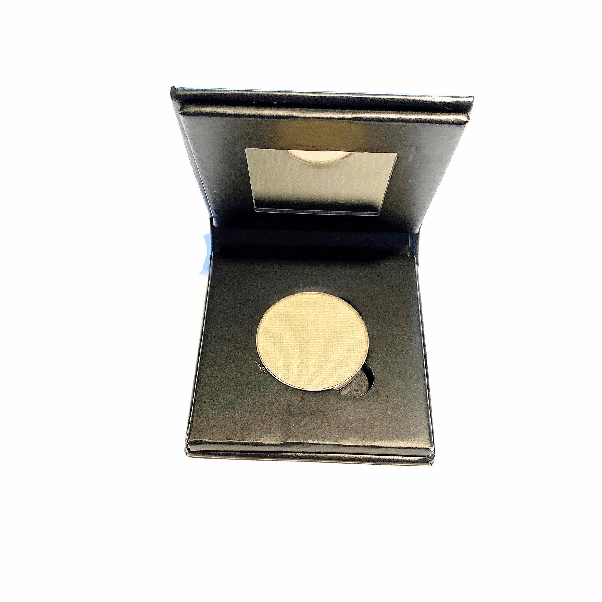 Close-up of vibrant lemon yellow mineral eye shadow in a natural paperboard compact, showing powdery texture