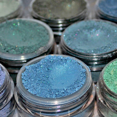 Blue and green eye shadow palette with shimmering shades in a sleek black compact case