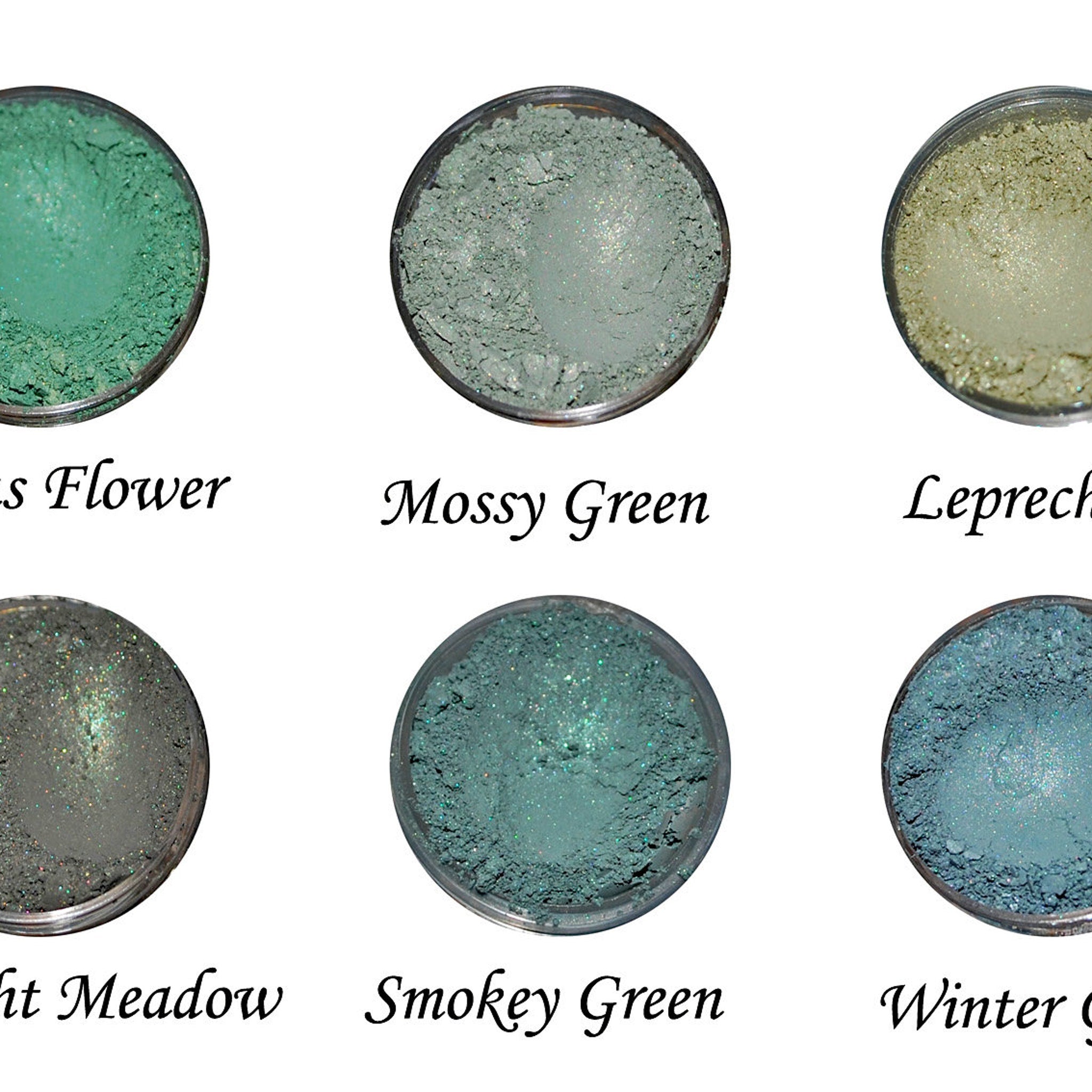 Side view of blue and green eye shadow palette showing textured powder surfaces and compact case design
