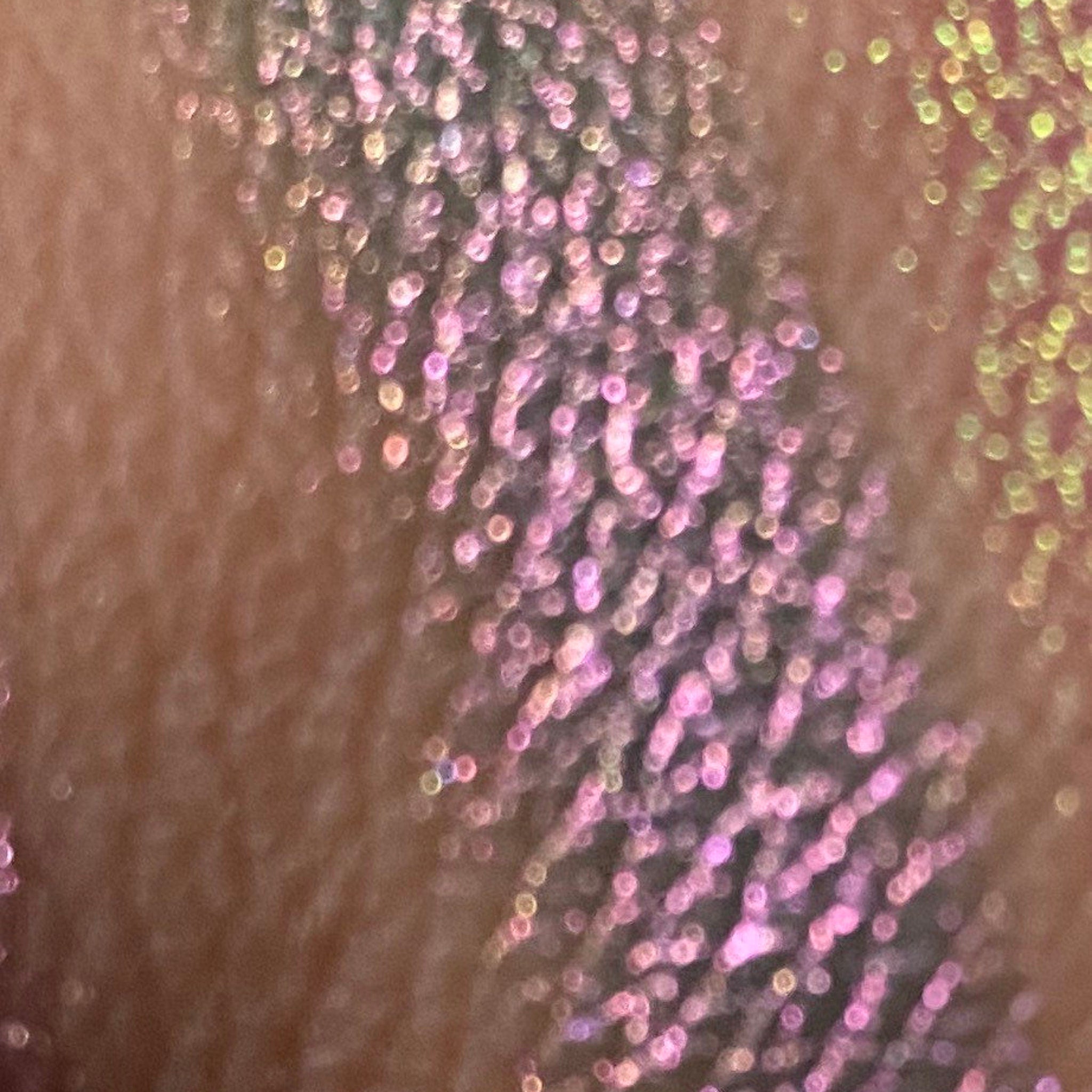 Open compact showing multichrome unicorn tracks eyeshadow with iridescent shifting hues in a sleek black case