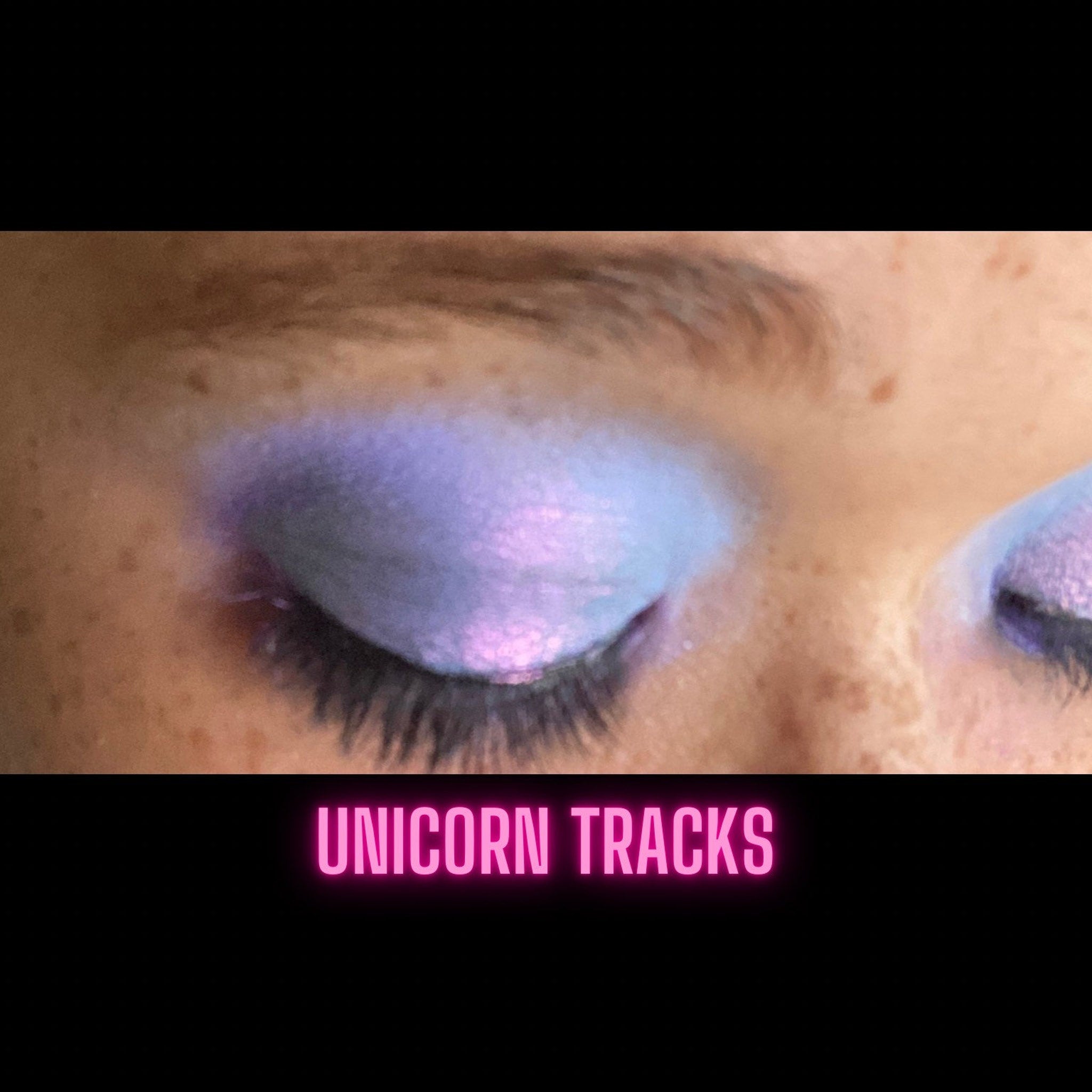 Side view of Multichrome Unicorn Tracks eyeshadow showing shifting rainbow hues in compact palette