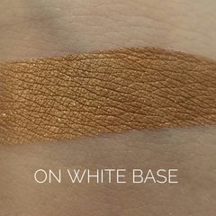 Close-up of warm copper eye shadow with metallic shimmer in compact pan