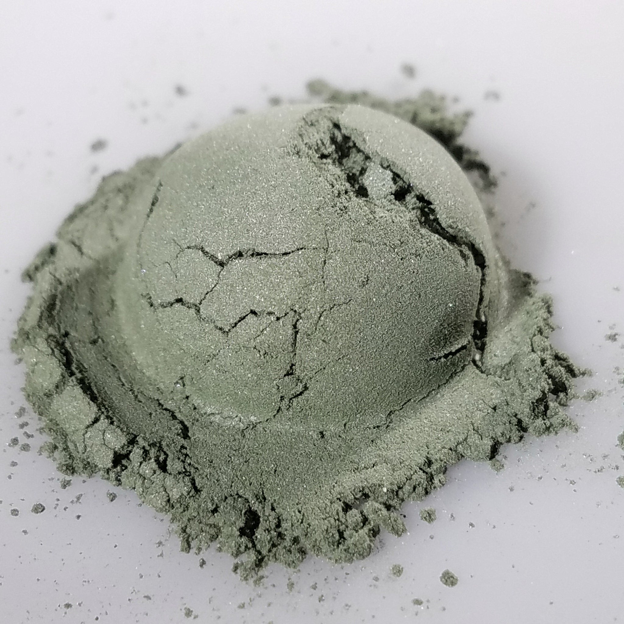 Close-up of Camouflage Eye Shadow palette showing matte neutral shades in a sleek black compact