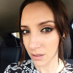 Side view of nude-toned organic eye shadow primer tube with matte finish and cruelty-free label