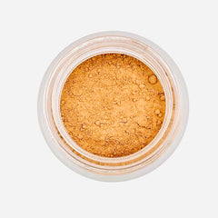 Powder makeup in a clear jar with light brown powder and a white rim, overhead shot