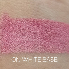 Close-up of rosy pink and bronze eye shadow palette with shimmering metallic finish and smooth powder texture