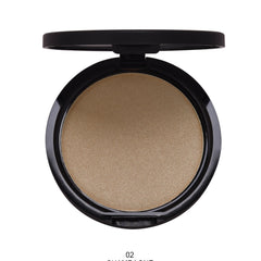 Close-up of a makeup brush applying shimmery highlighter powder to eyelid for a glowing eye look