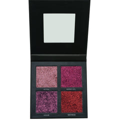 Eyeshadow palette with glittery pink, purple, and red shades in a black compact with mirror
