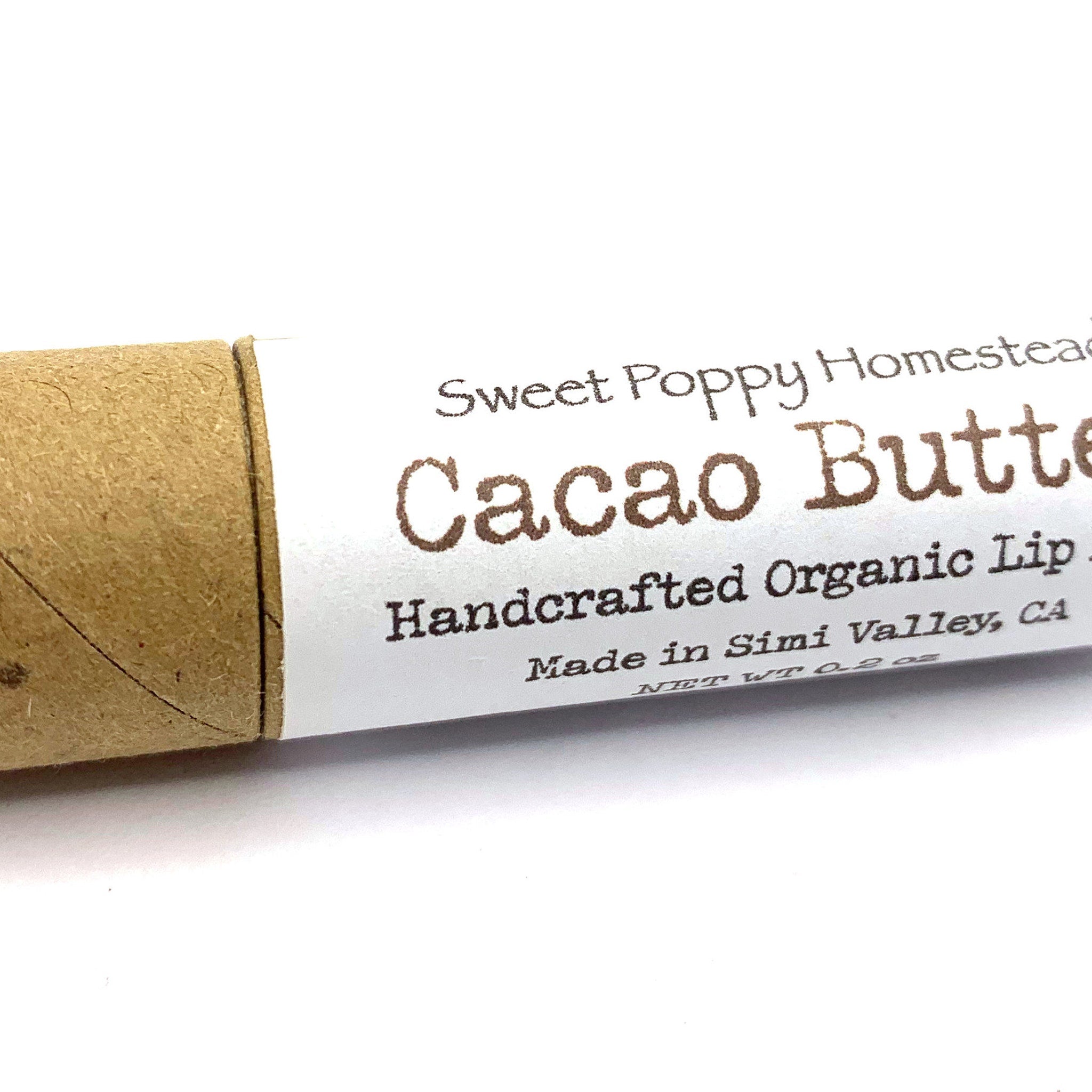 Cacao Butter lip balm in brown cardboard tube with Sweet Poppy Homestead text on white label