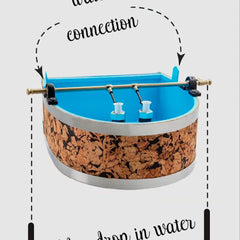 Water feature with cork and blue interior, brass fixtures, and silver trim around the rim.