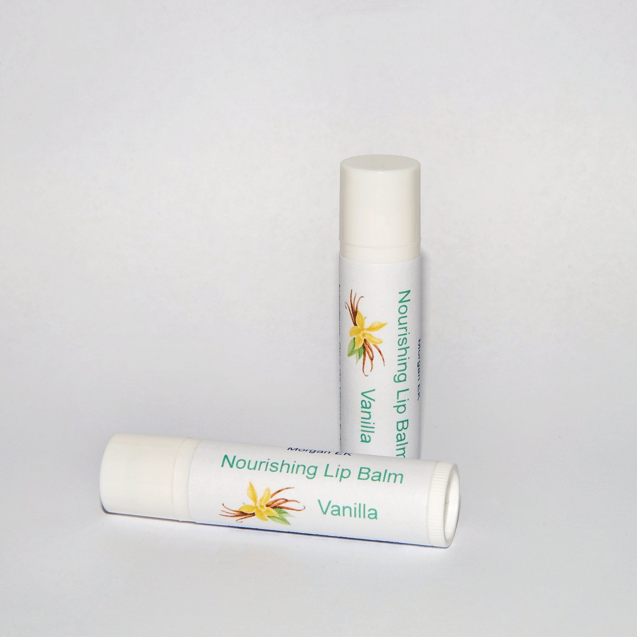 Lip balm tubes, white with green text and vanilla label, MorganEK brand shown