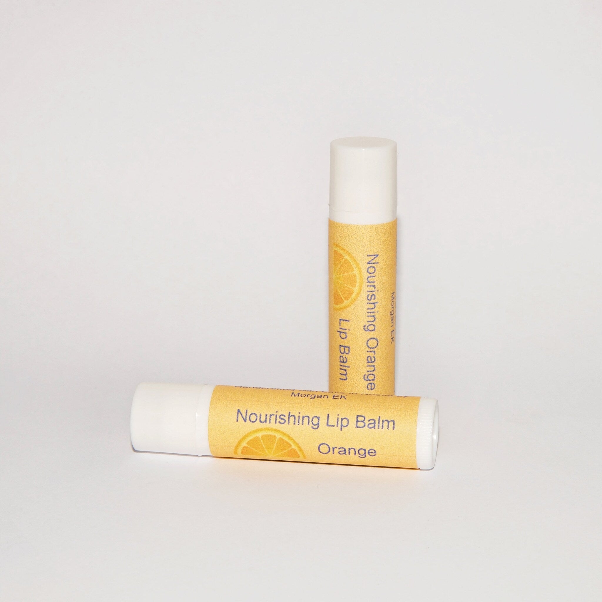 Lip balm orange tube with white cap and Morgan EK branding