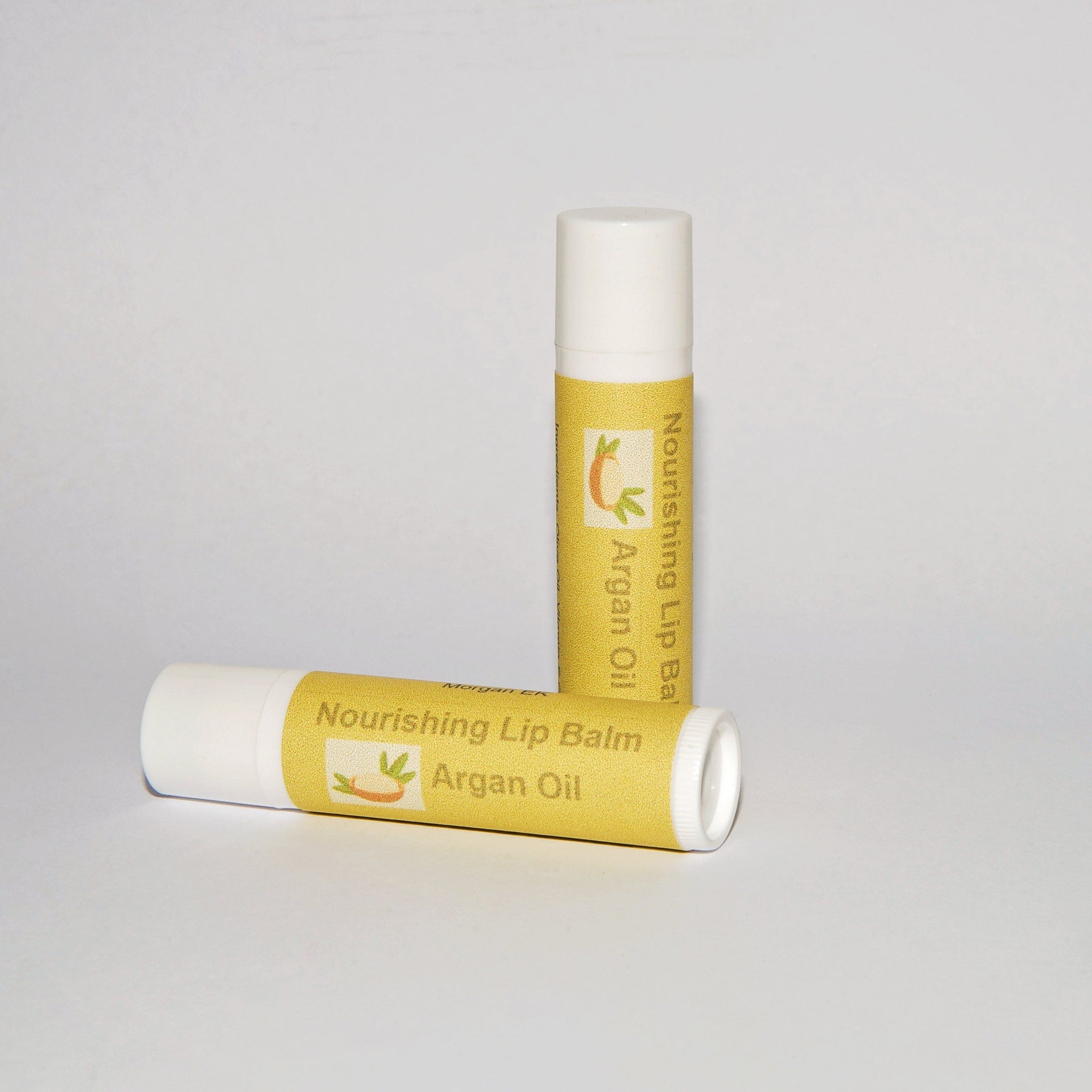 Lip balm tubes with white, yellow, and printed label, MorganEK brand shown