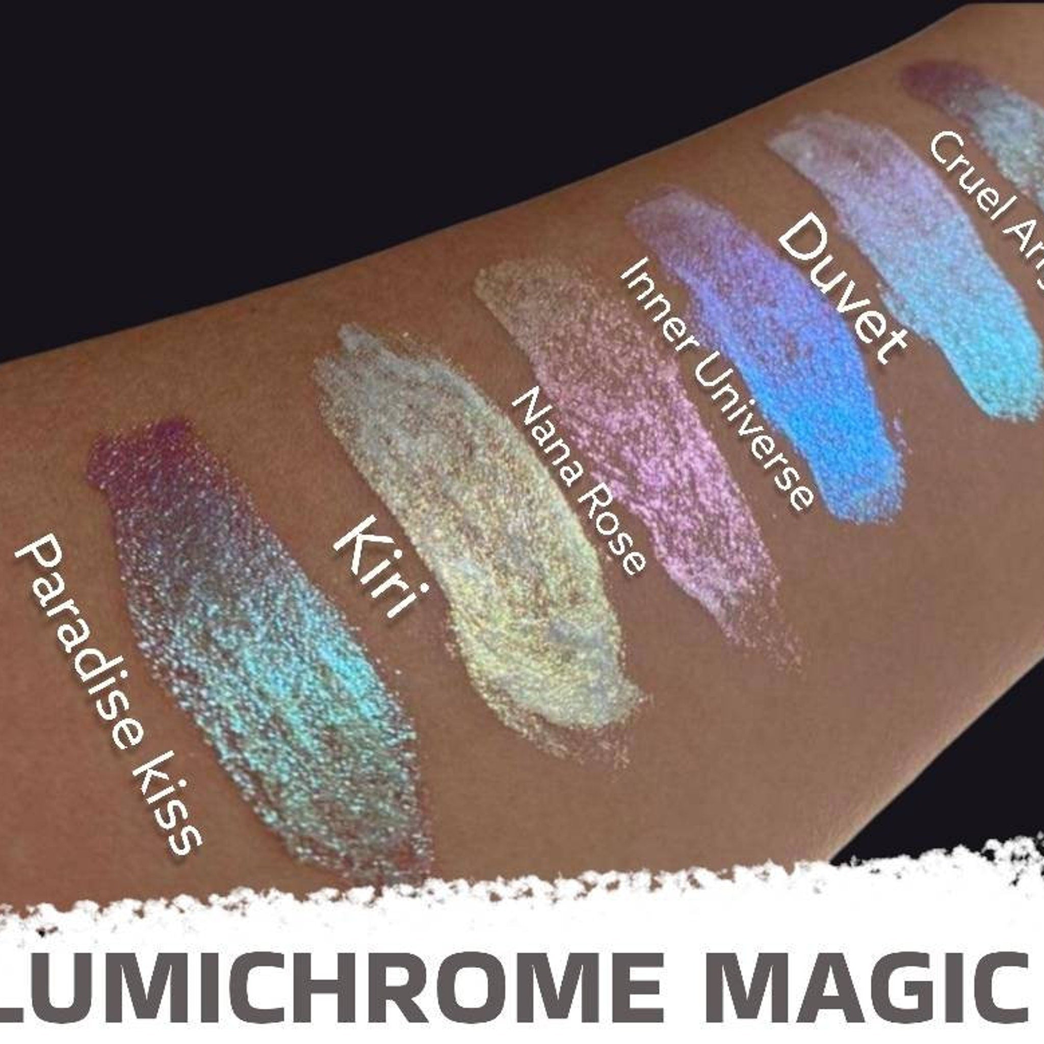 Close-up of fingertips applying shimmery duochrome liquid eyeshadow in shifting violet-blue hue