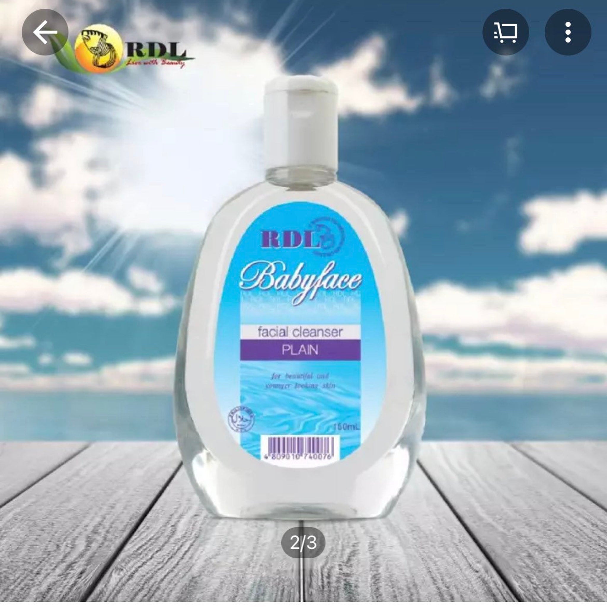 Facial cleanser bottle with white cap, blue label, and RDL Babyface branding on wooden surface