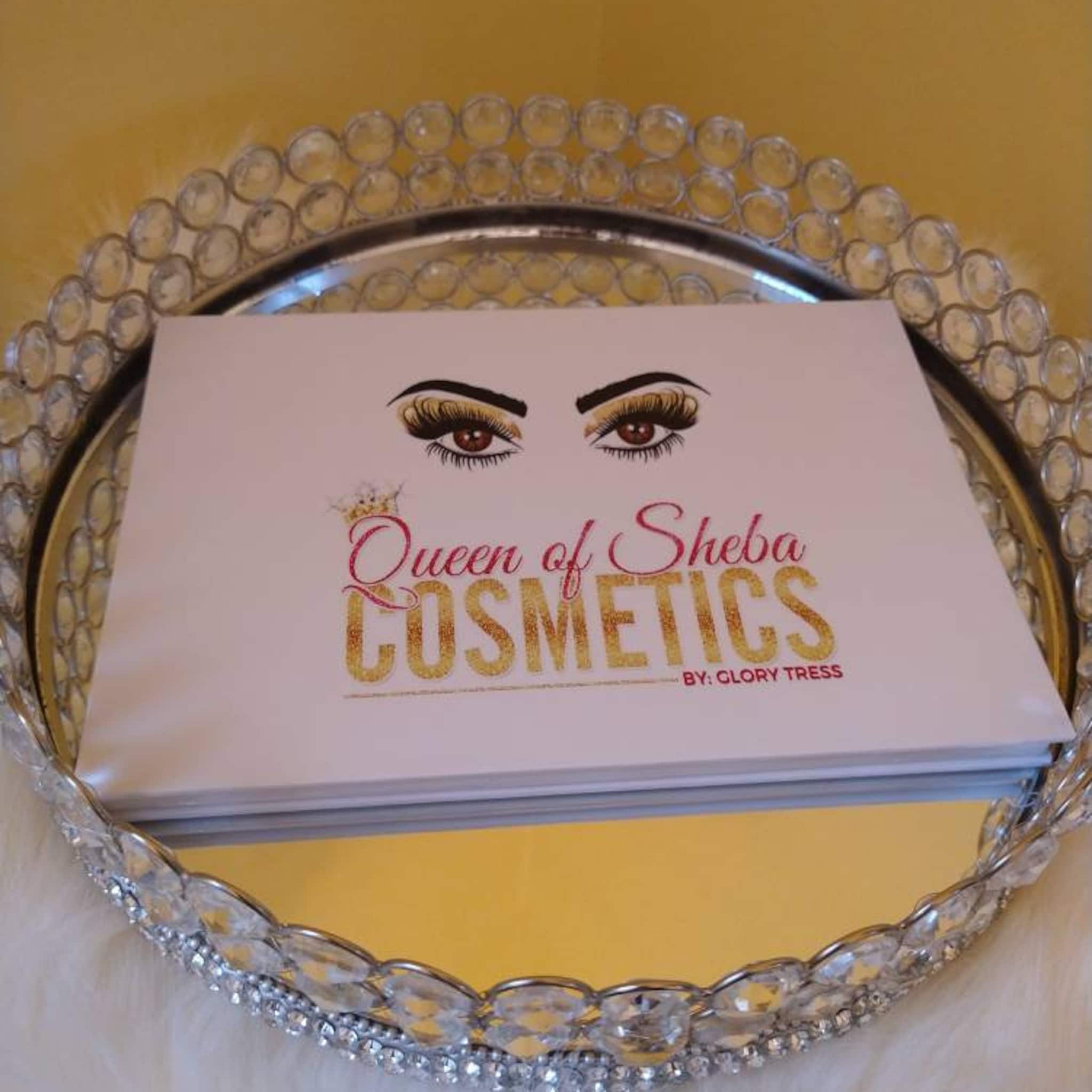 Queen of Sheba Cosmetics box with pink and gold text, on a silver tray with clear crystals
