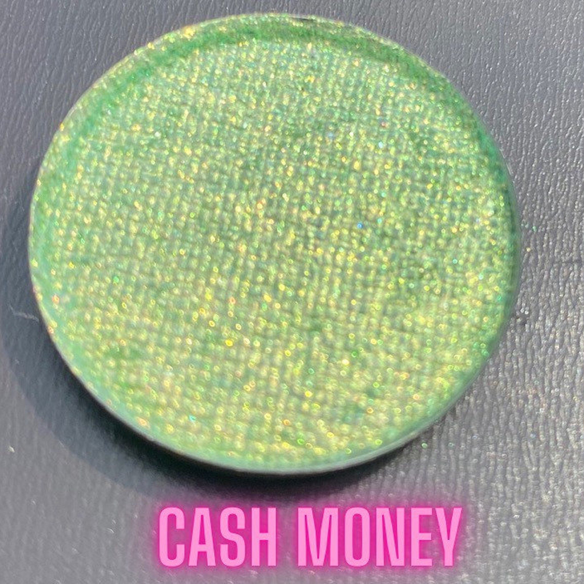 Side view of multichrome eyeshadow palette showing shifting iridescent hues in compact case