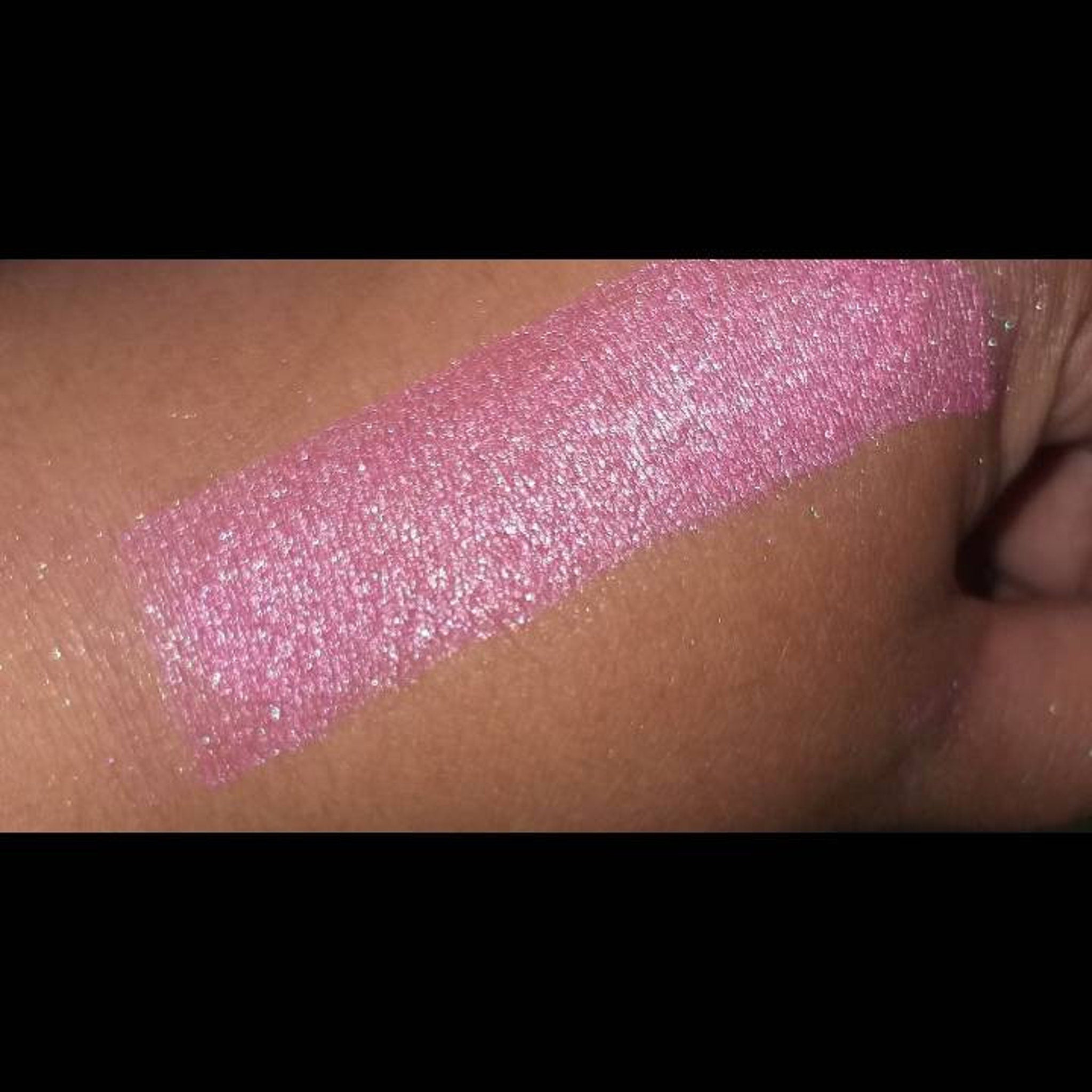Pink metallic swatch on skin, showing color and shimmer