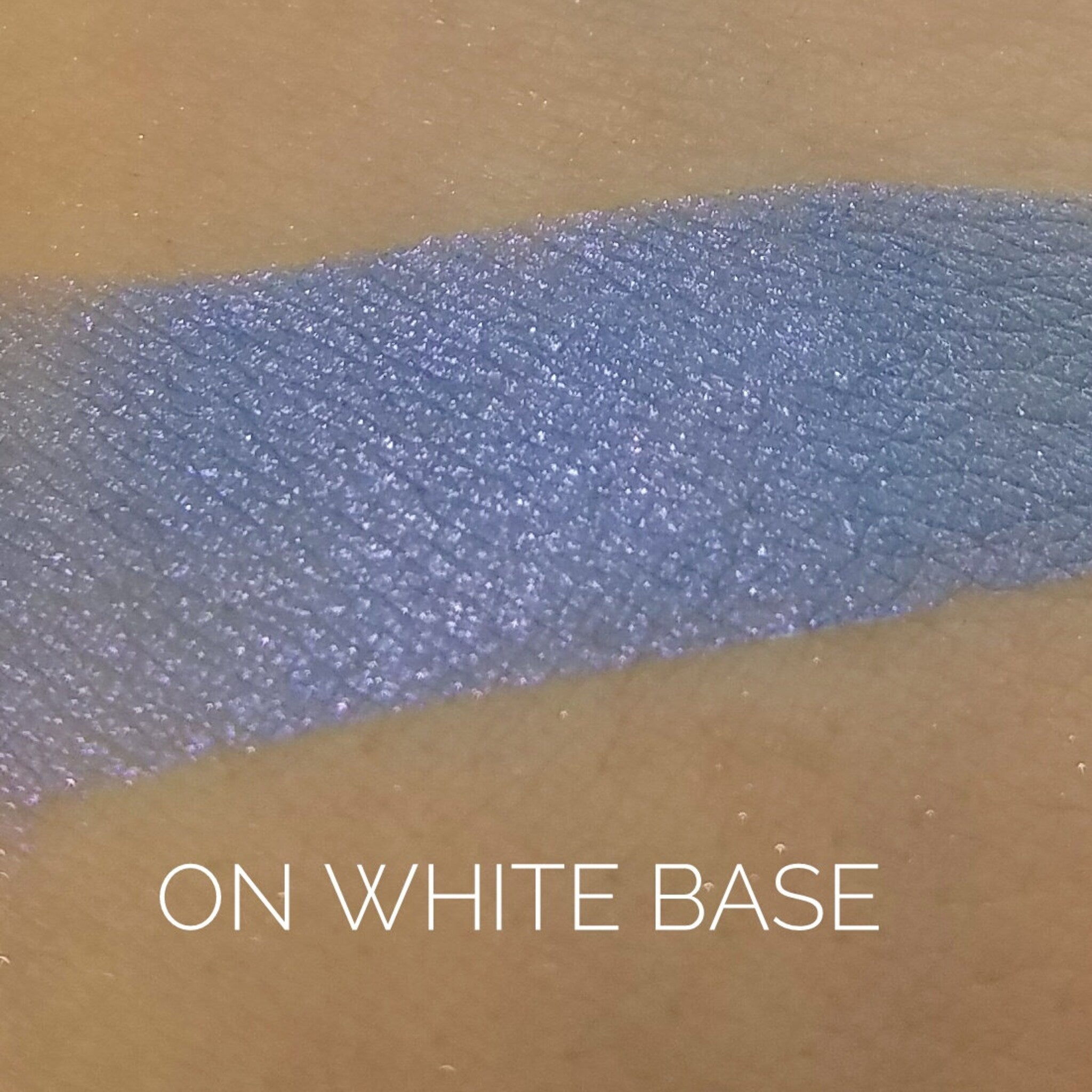 Close-up of shimmering Mystic Eye Shadow palette showing rich violet and silver tones with smooth, blendable texture