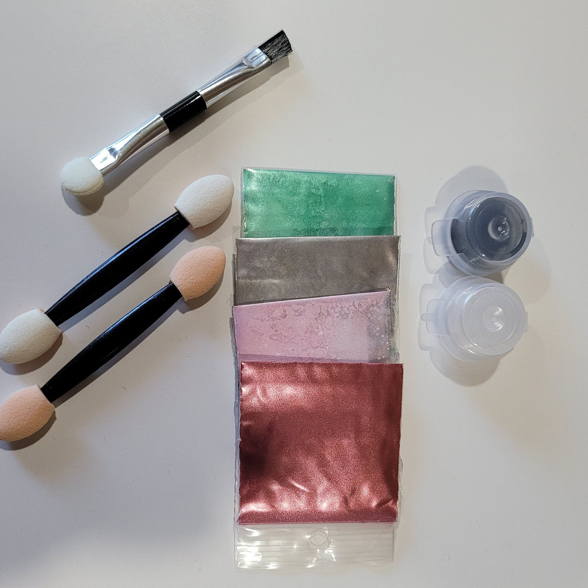 Side view of rosy eye shadow palette showcasing six warm-toned matte and shimmer shades in compact case