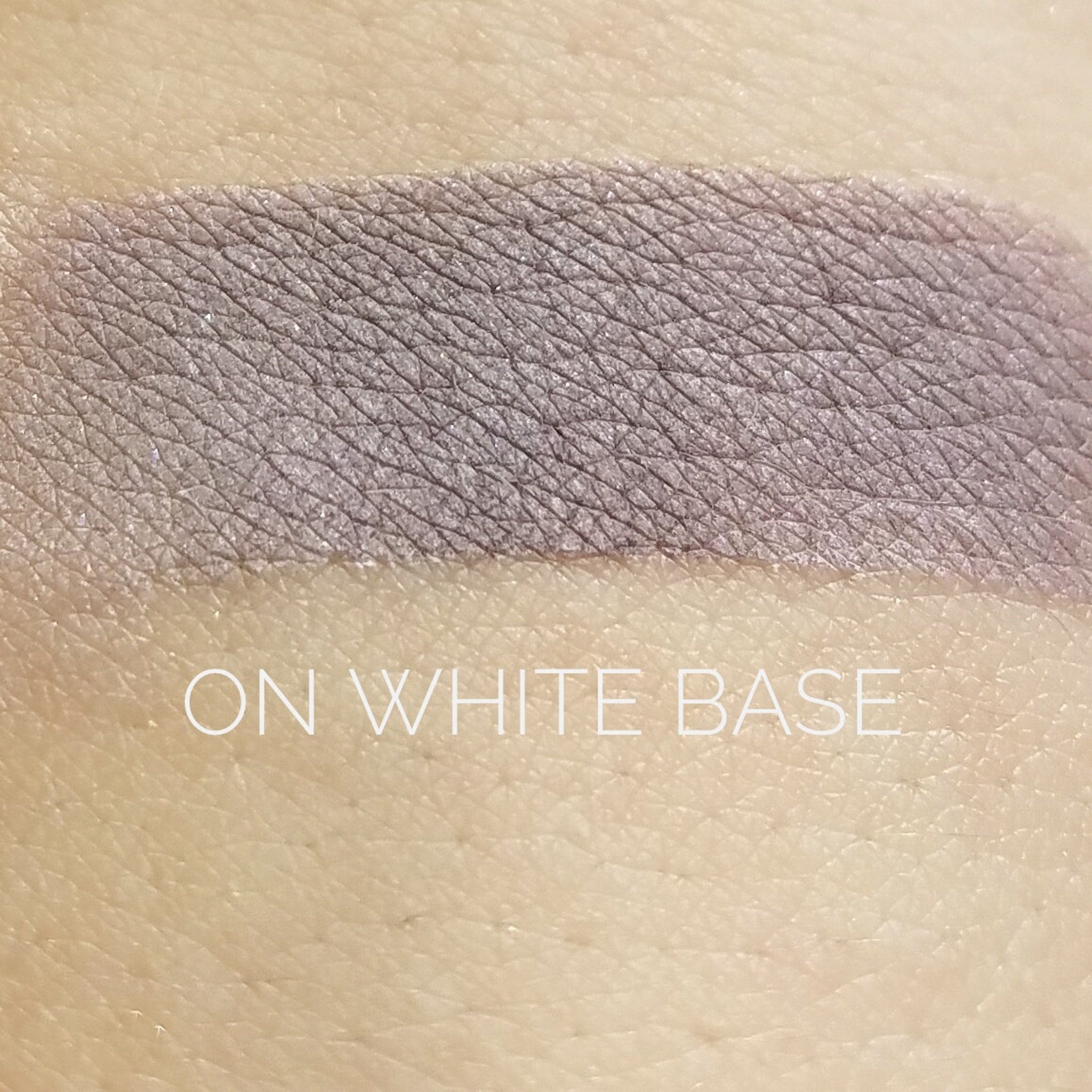 Close-up of Ominous Eye Shadow pan showing deep matte black pigment with smooth velvety texture