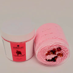 Sugar scrub in clear container with pink swirl, dried rose petals, Ameelah Essentials label