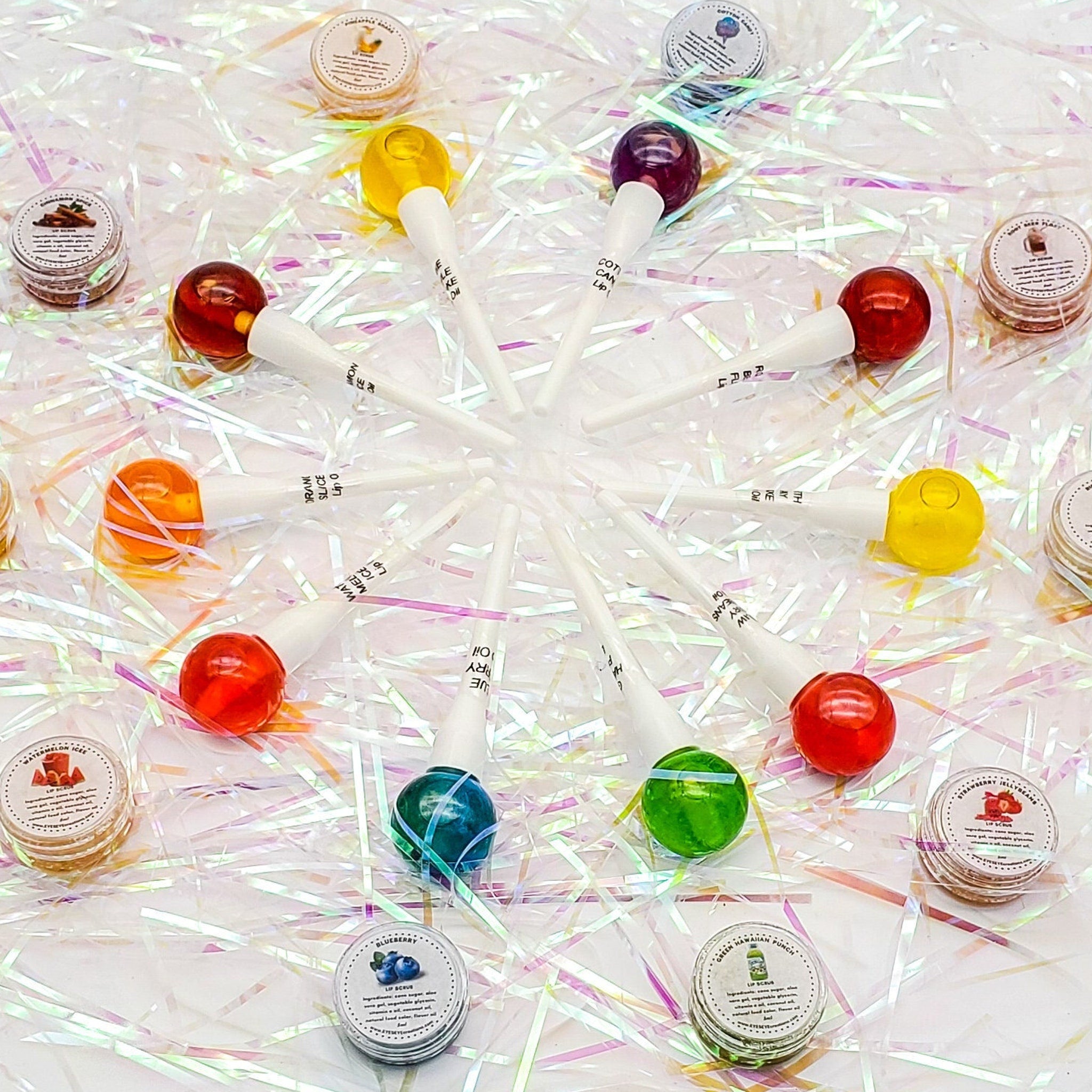 Lollipops with colorful round candy, white sticks, and text visible on the sticks, arranged in a circle