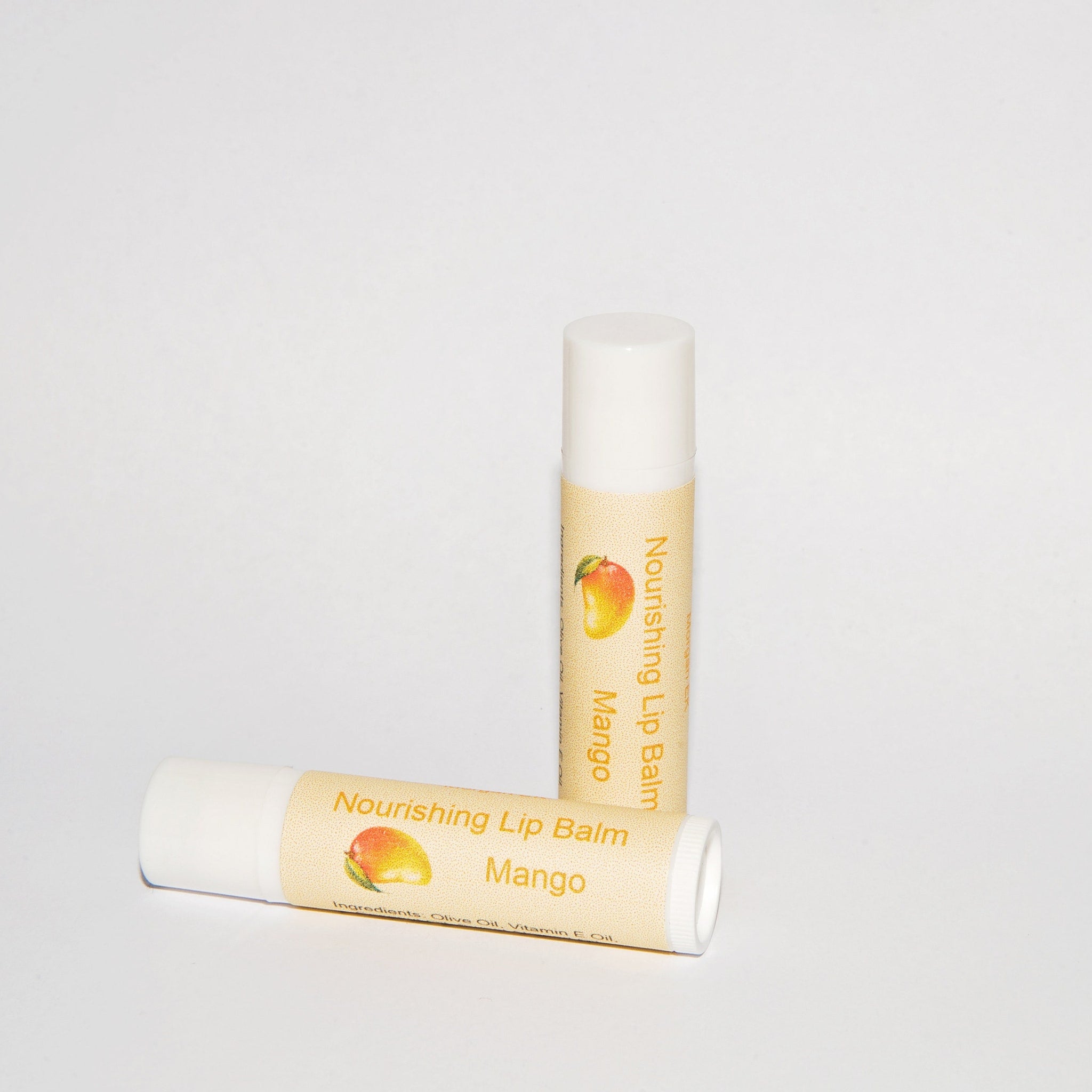 Lip balm tubes with white caps, tan labels, and mango illustration, for lip care