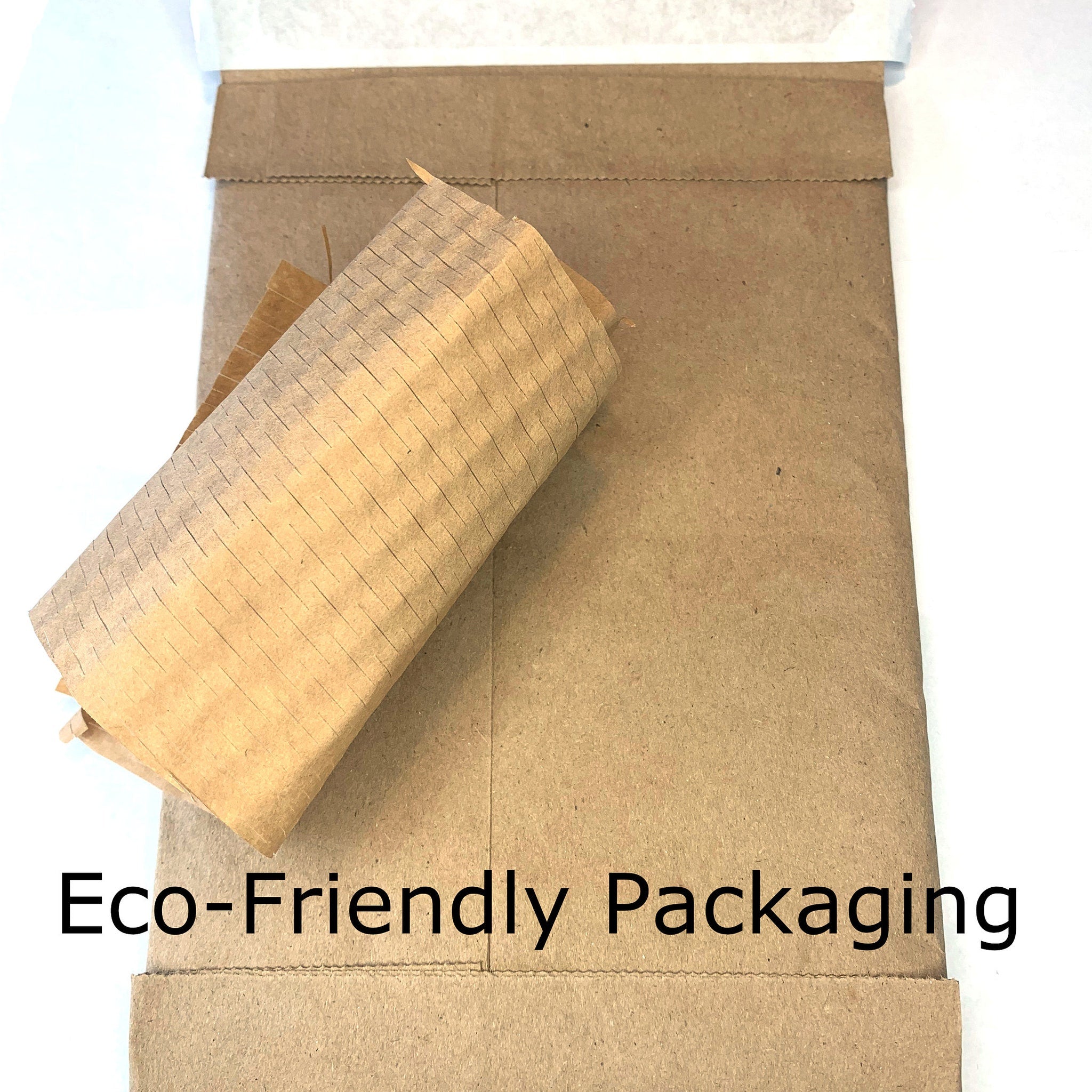 Eco-friendly packaging featuring brown paper and corrugated paper wrap, text visible