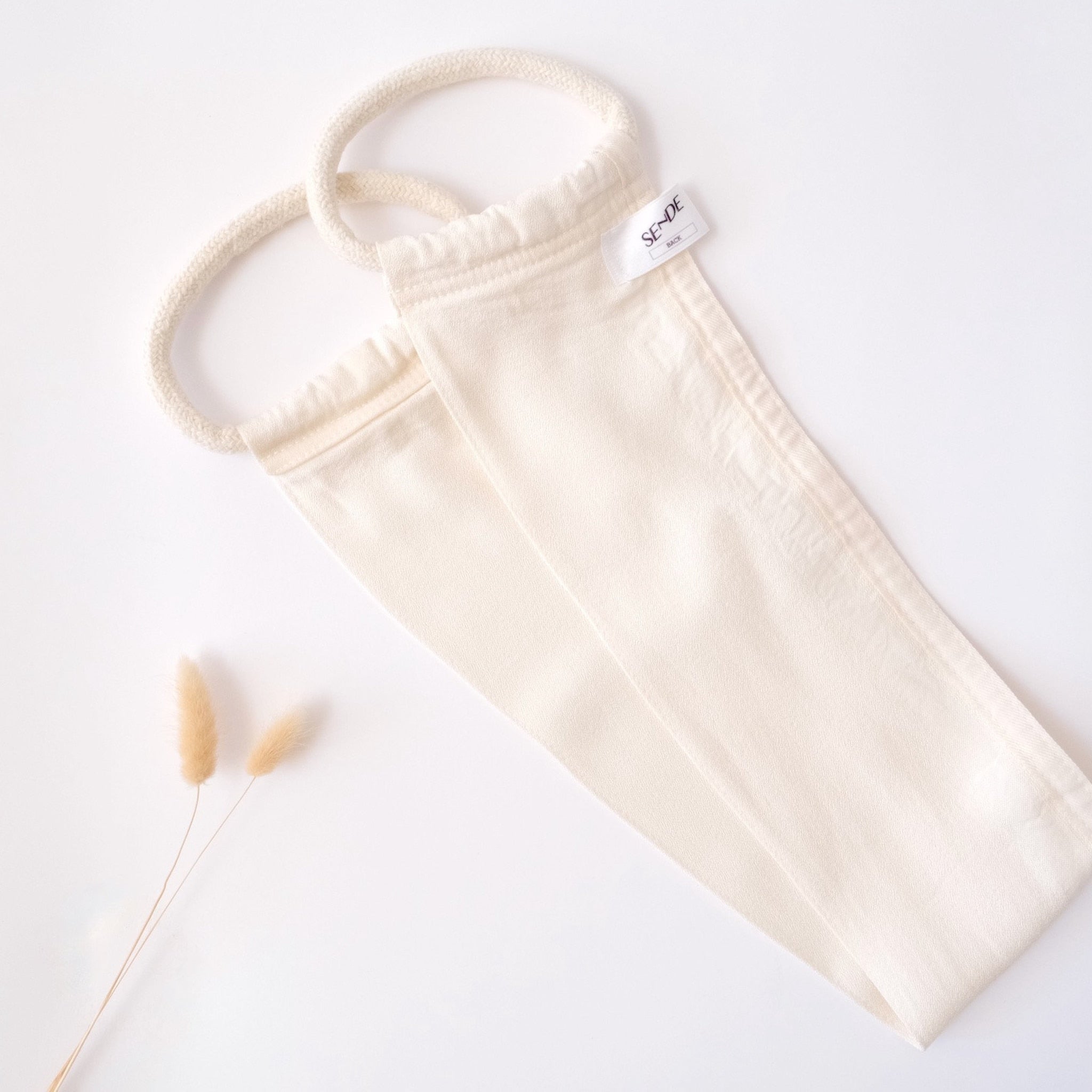Back exfoliating kese, off-white fabric with rope handle, SENDE brand label visible