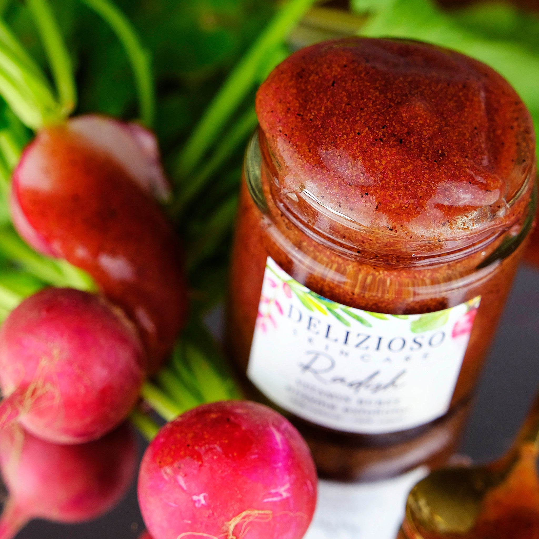 Radish jar with red spread, glass jar, and fresh radishes with green stems
