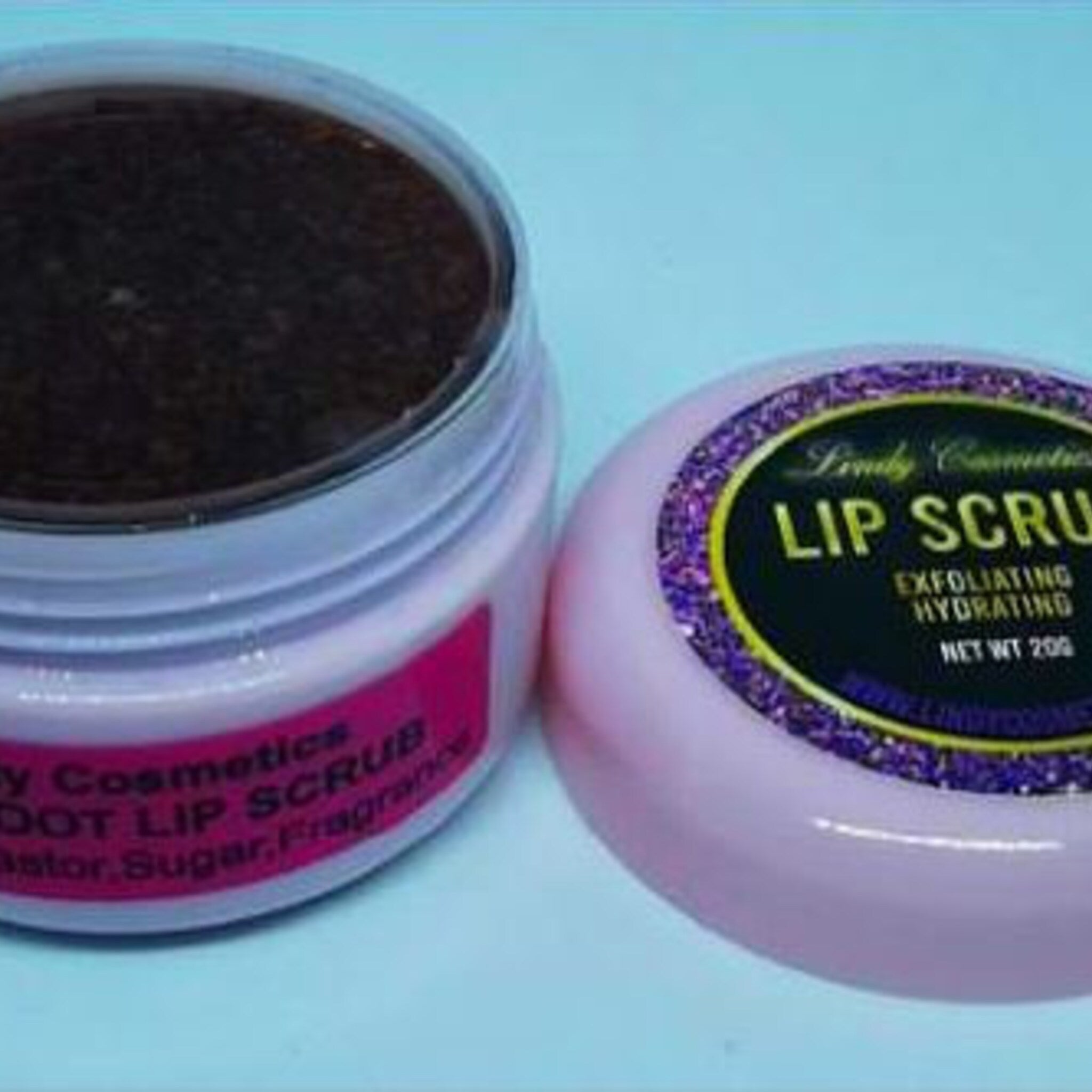 Lip scrub in a pink jar with black granules and purple glitter lid, Lively Cosmetics brand