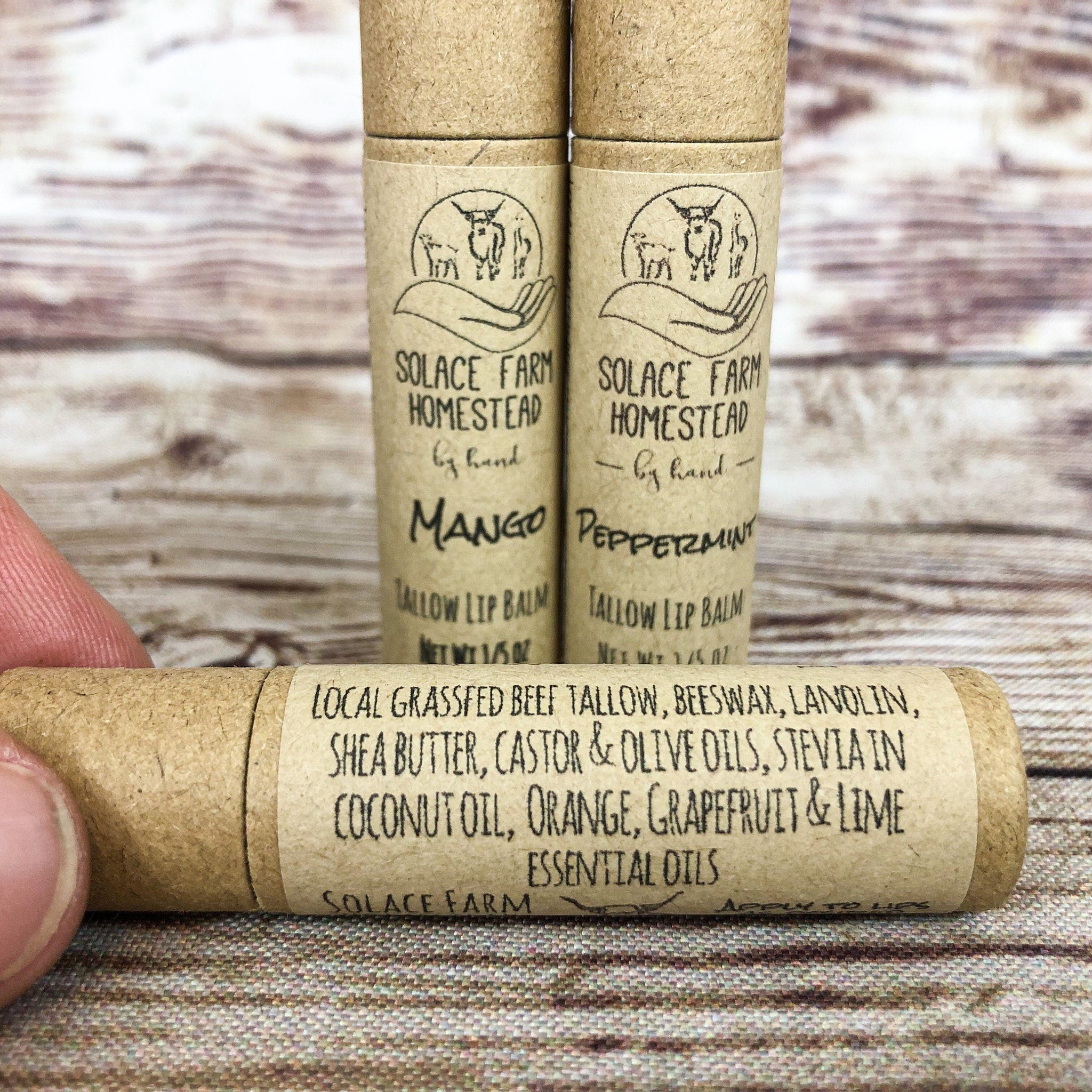 Lip balm tubes with brown paper packaging, black text, and Solace Farm logo