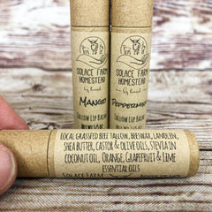 Lip balm tubes with brown paper packaging, black text, and Solace Farm logo