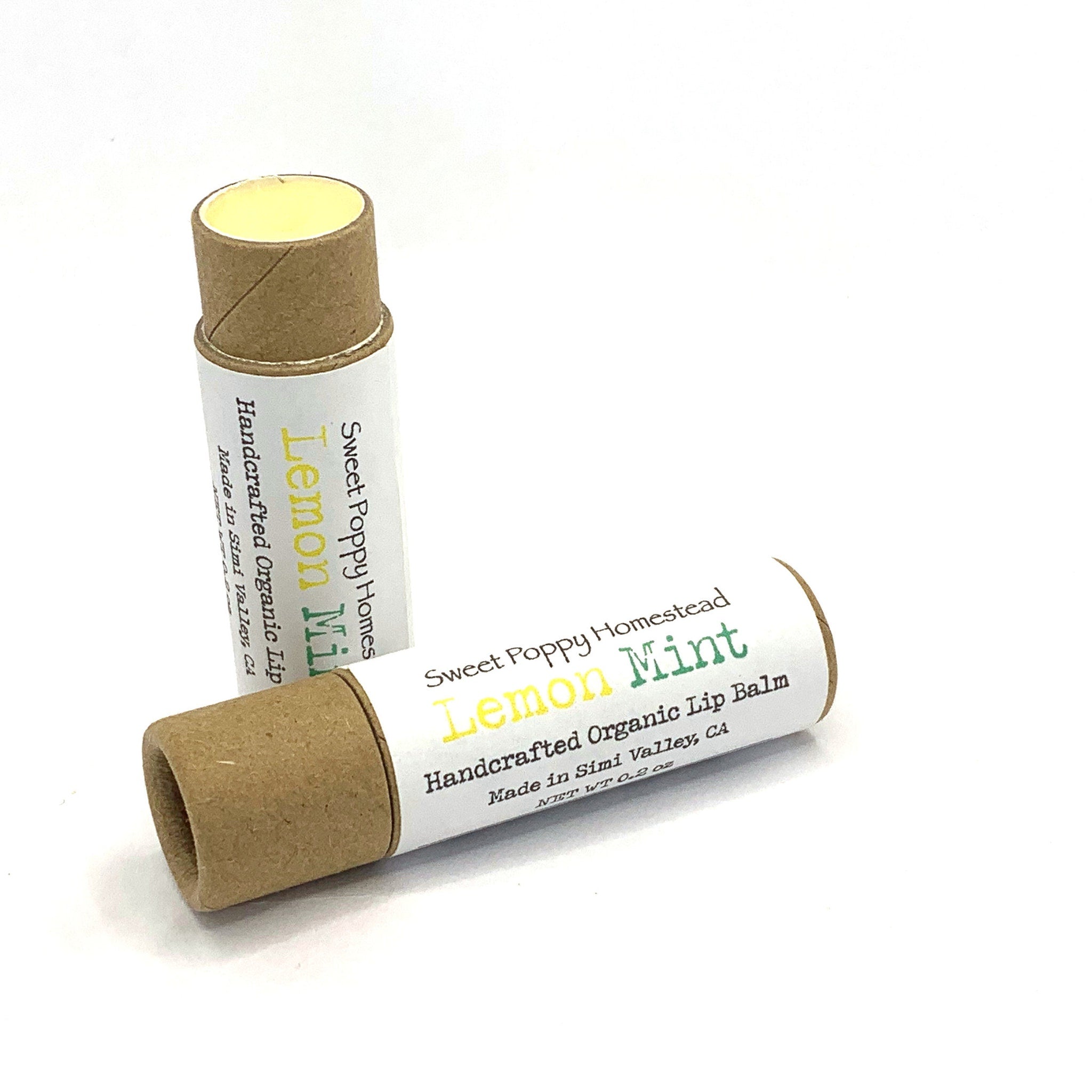 Lip balm tubes with yellow balm, brown cardboard, and Sweet Poppy Homes text visible