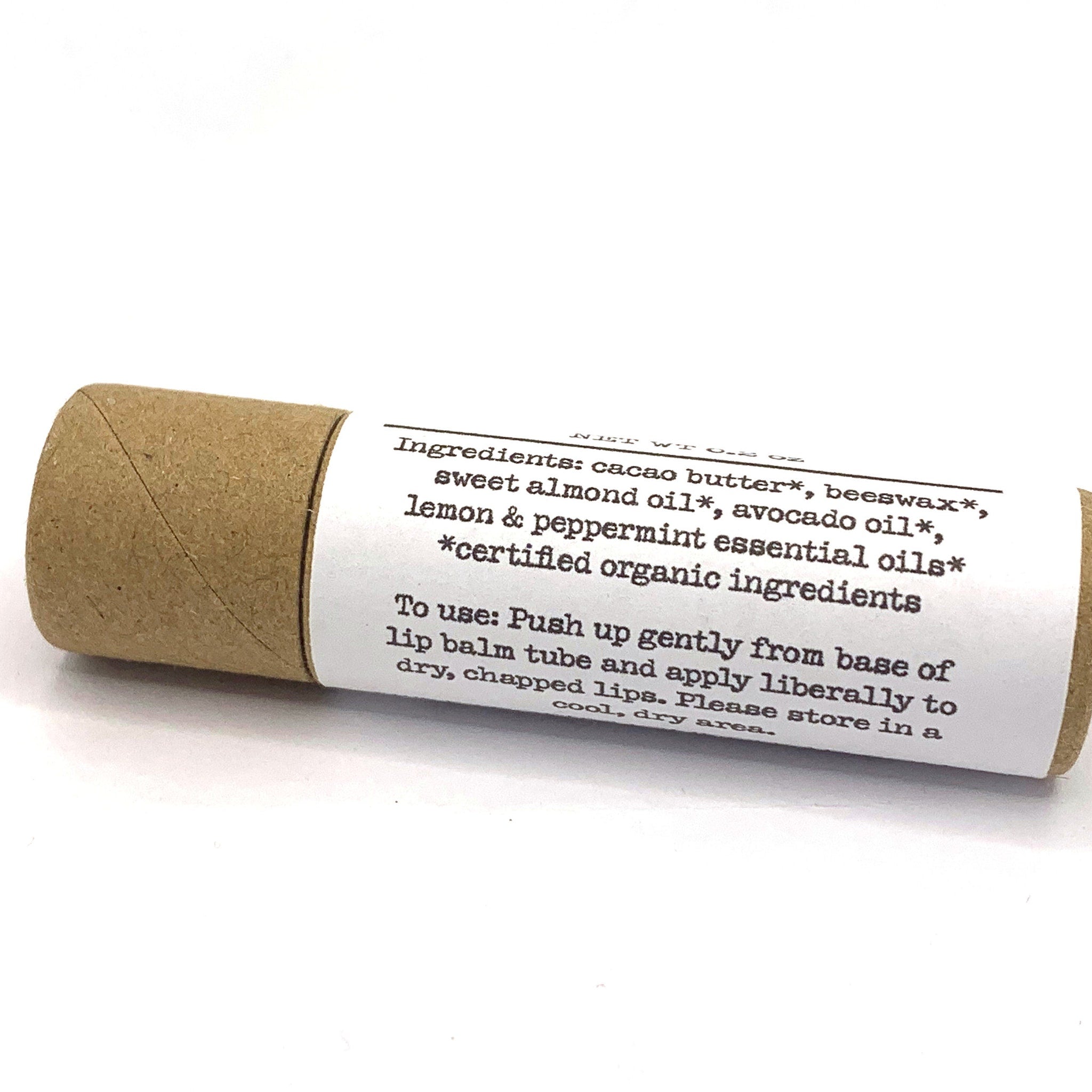 Lip balm tube with brown cardboard and white label, for dry chapped lips application