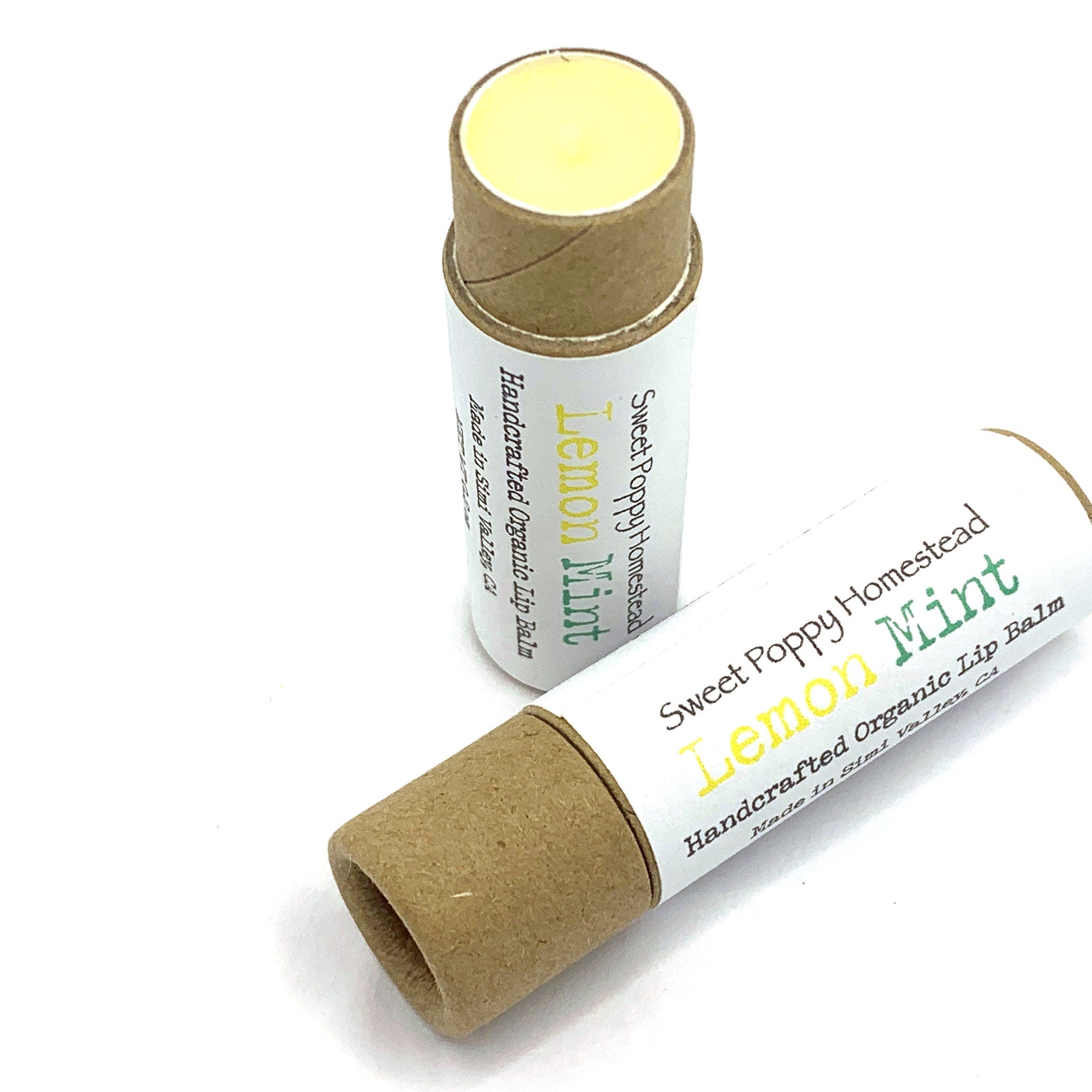 Lip balm tubes with yellow balm, brown cardboard, and Sweet Poppy Homestead label