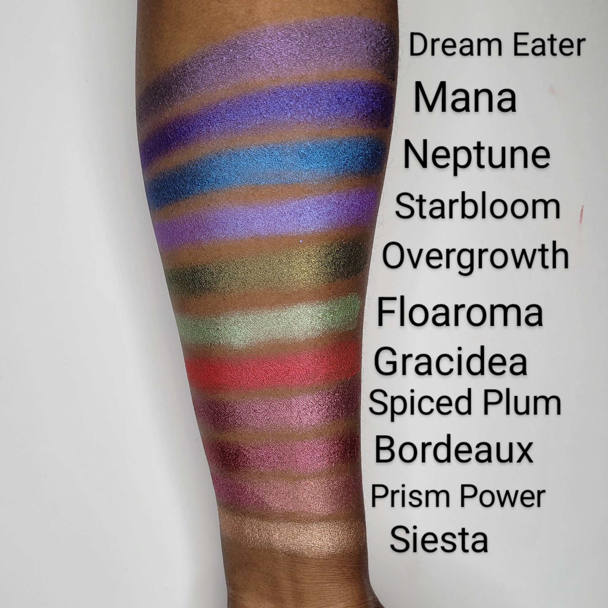 Close-up of fingertips applying vibrant hot pink eyeshadow with smooth, pigmented texture to eyelid