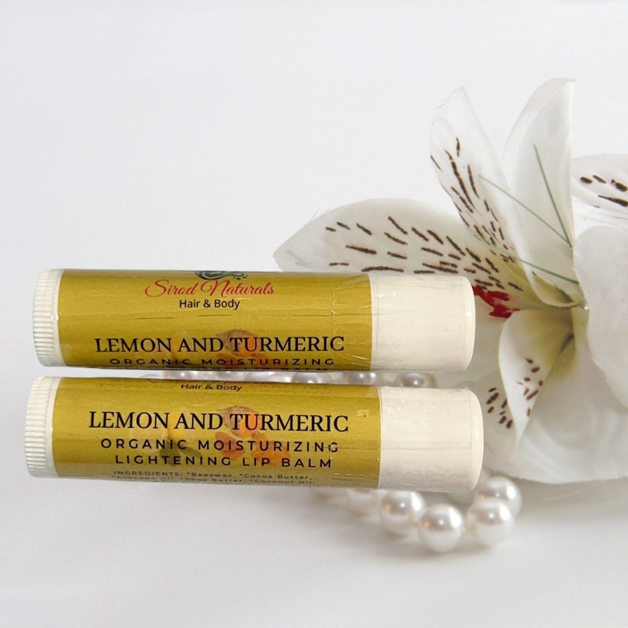 Lip balm tubes with yellow and white labels, Sirod Naturals brand, with flower and pearls