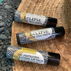 Lip balms with black tubes and wave pattern, Eclipse brand visible on label