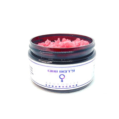 Sugar scrub in a glass jar with pink granules and white label, "Gigi Berry" text visible