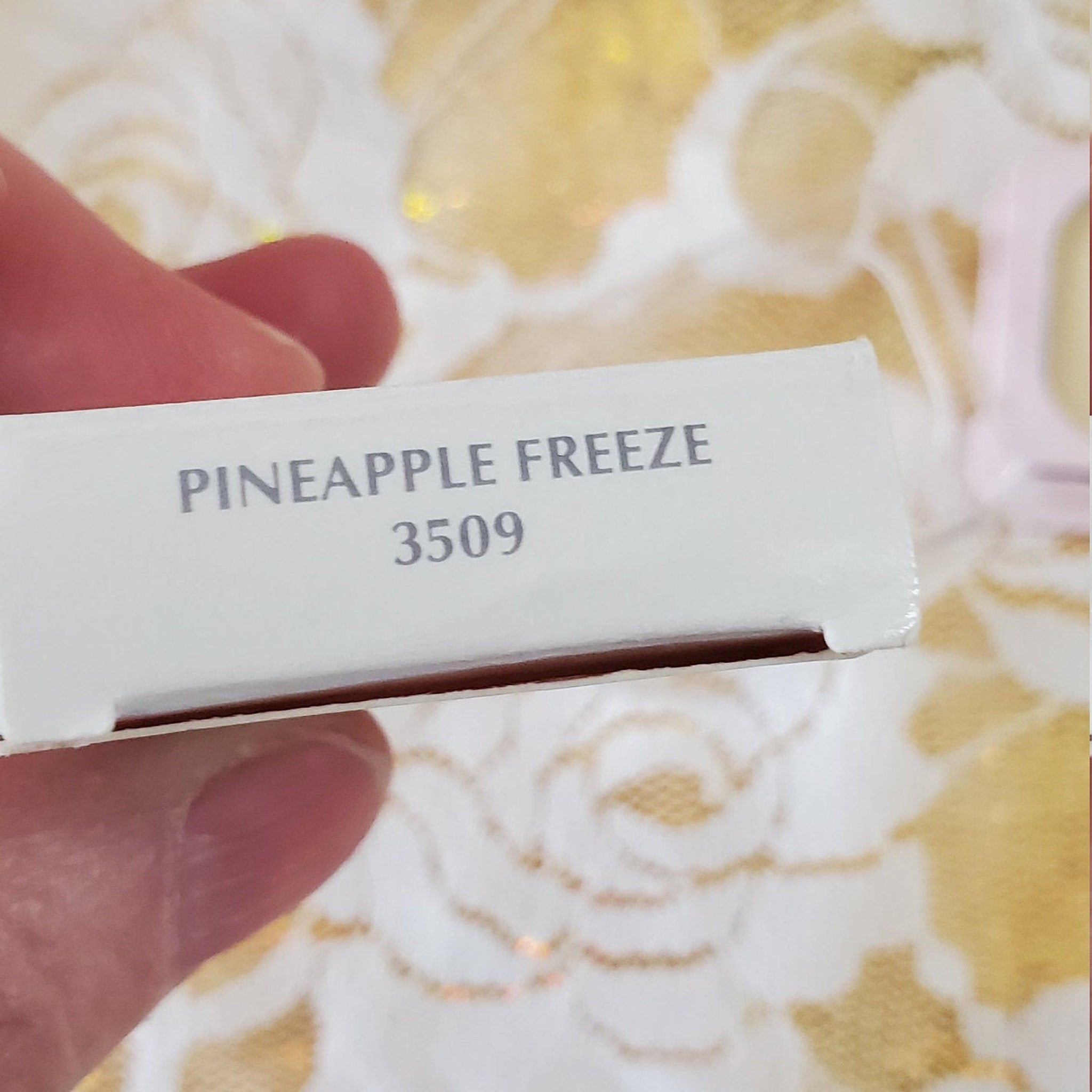 White box with "PINEAPPLE FREEZE" text, light gray font, and "3509" number detail