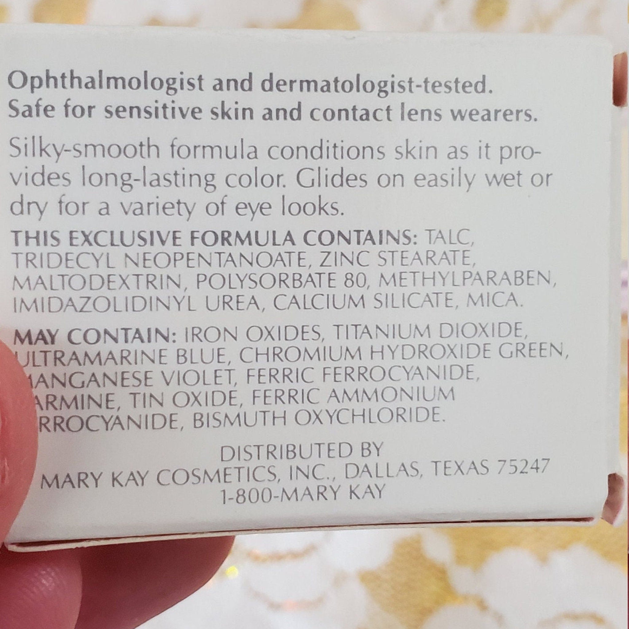 Mary Kay cosmetics product label with white background and black text, held by a hand